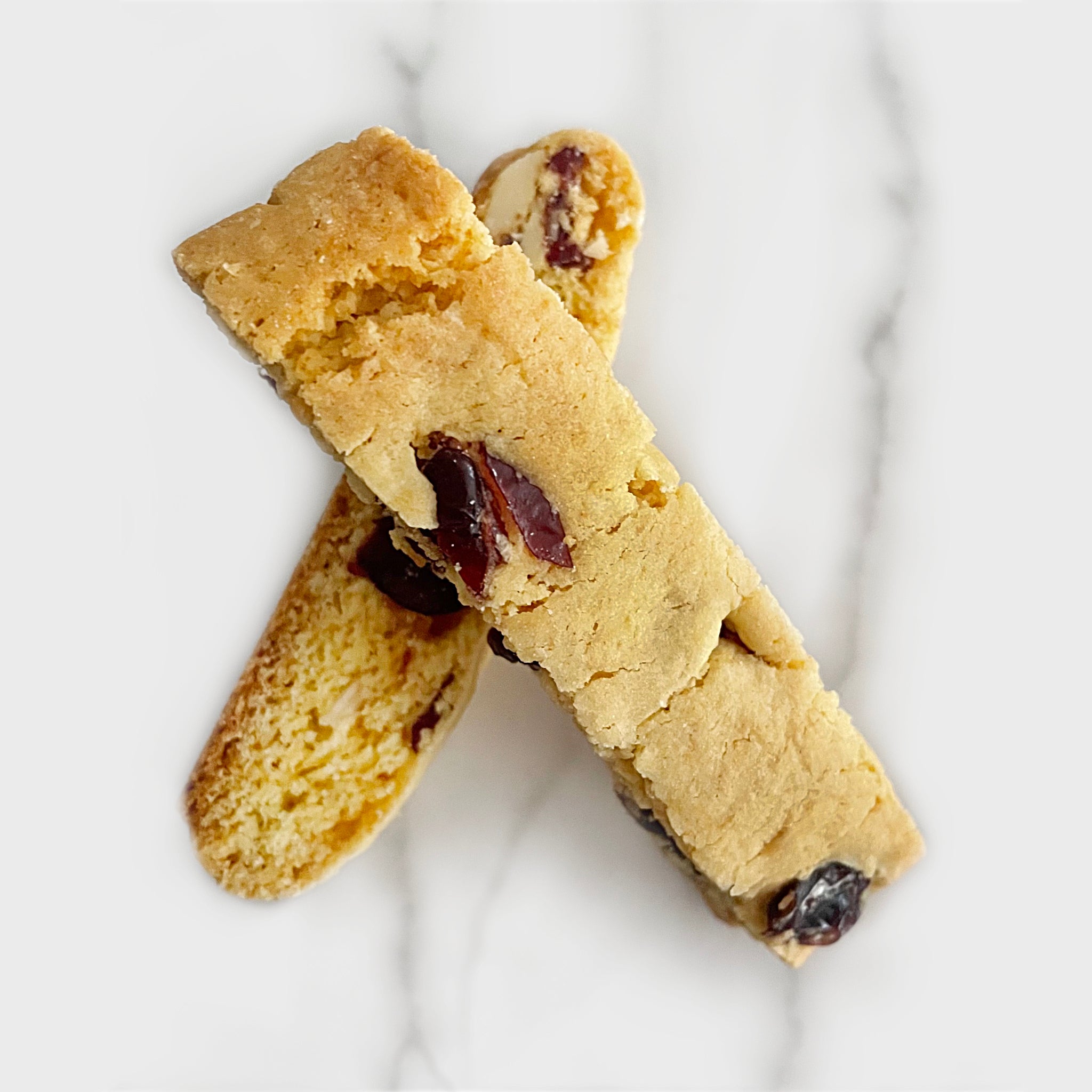 http://sorellebiscotti.com/cdn/shop/products/sorelle-biscotti-cranberry-almond-biscotti-cookie-on-marble.jpg?v=1679655936