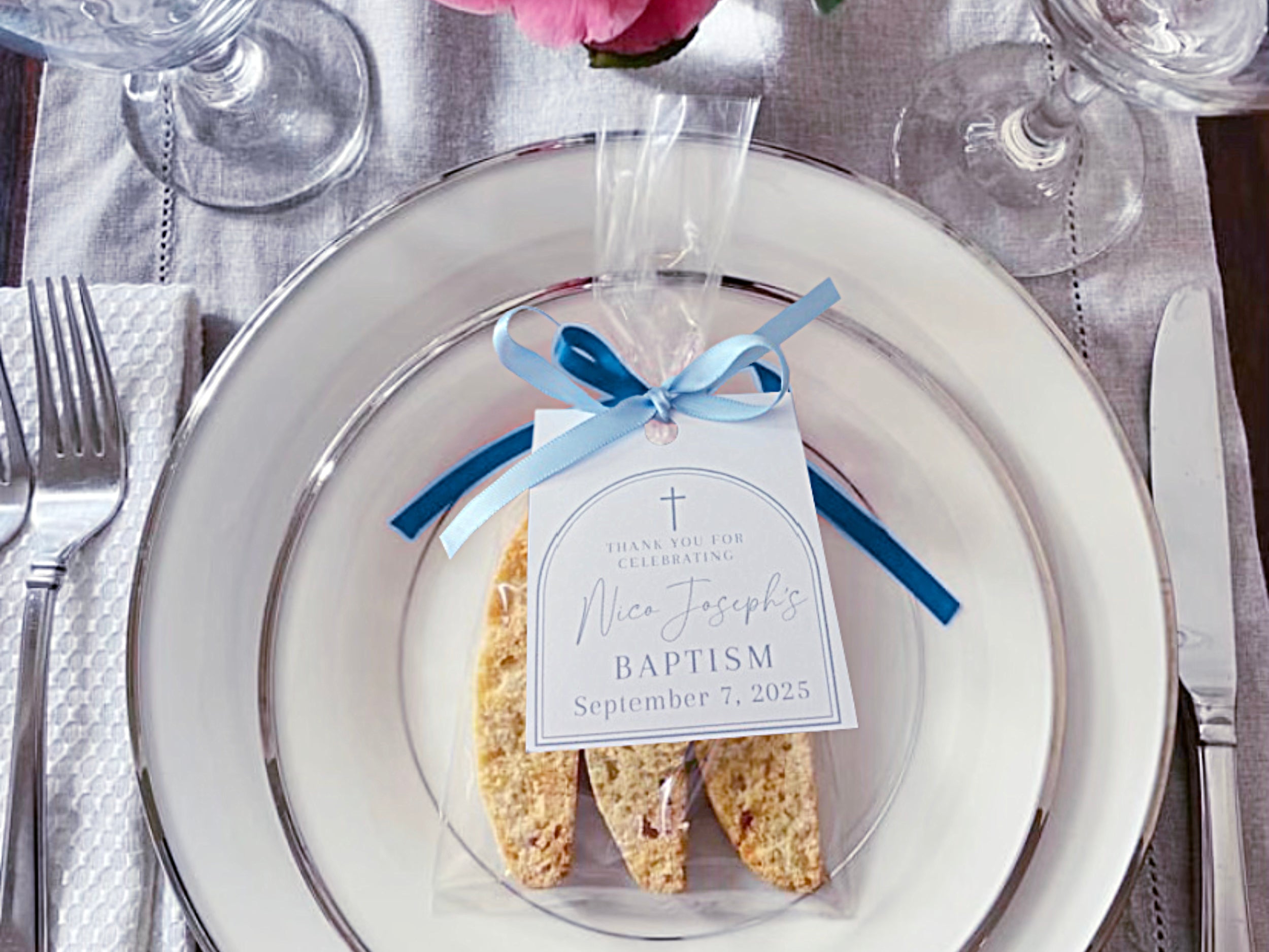 Sorelle Biscotti 3 pack biscotti favor with a custom label and blue ribbons on a dinner plate setting