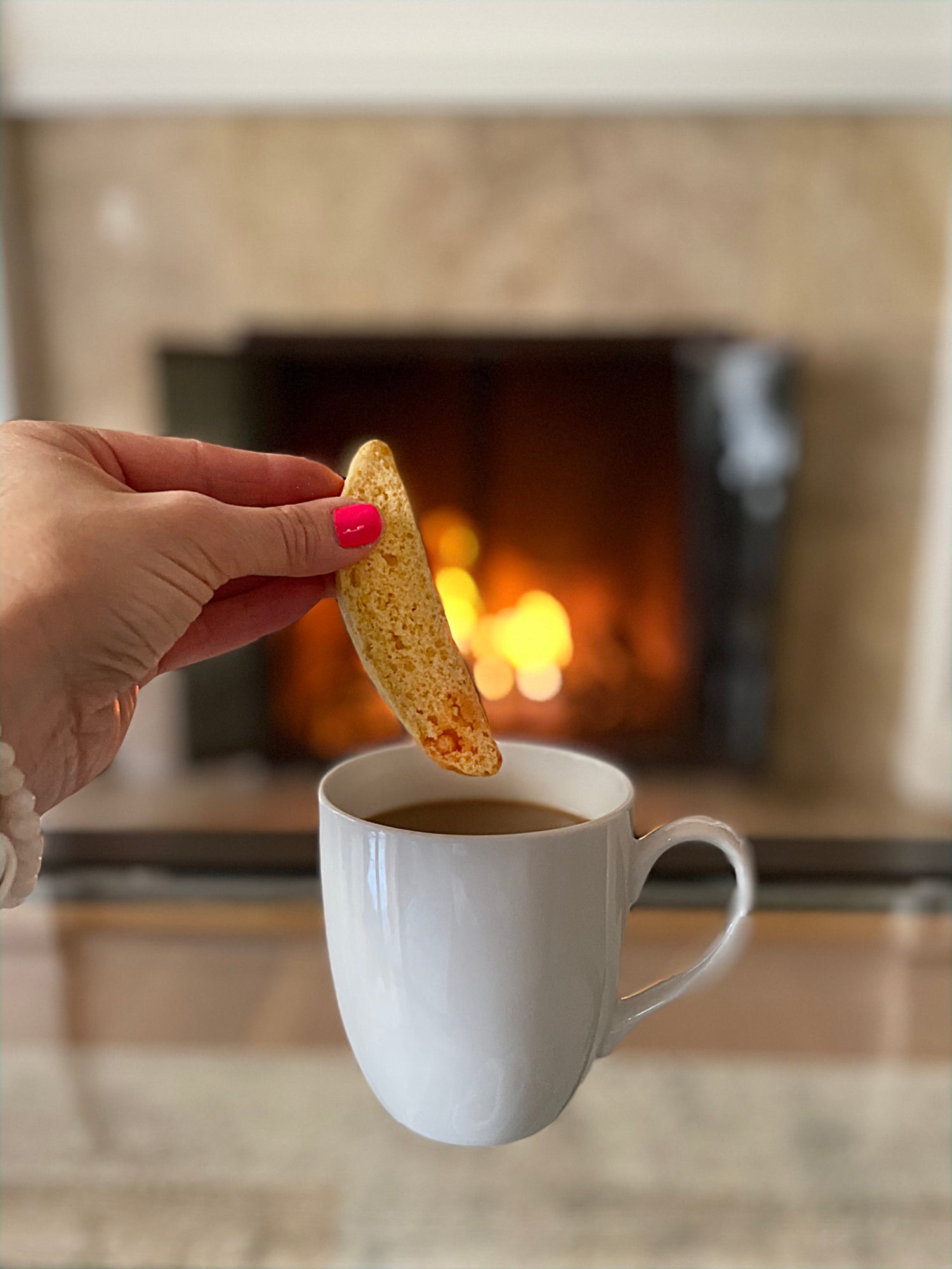 Sorelle Biscotti LLC coffee and biscotti cookie by fireplace